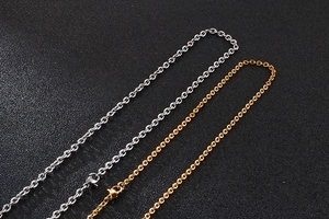 Detailed macro view of gold and silver O-chain necklaces with lobster clasp closures