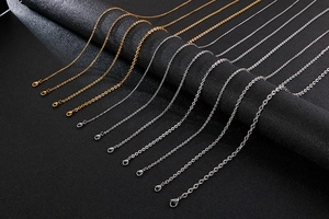 Detail view of gold and silver cable chains with lobster clasps in various thicknesses