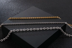 Close-up of gold and silver O-link chains with textured and polished finishes