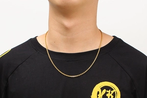 Close-up of minimalist gold O-chain necklace worn by model on neck showing detail