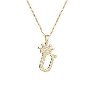 Macro shot of gold-plated crown letter U pendant necklace with sparkling cubic zirconia
