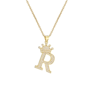 Macro detail of gold plated letter R pendant with crown and micro inlaid zircon stones