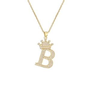 Macro shot of gold plated crown initial B necklace with micro paved cubic zirconia stones
