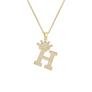 Macro detail of gold plated letter H pendant with micro-paved cubic zirconia crown