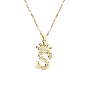 Macro shot of 18k gold plated necklace featuring crown letter S pendant with zircon inlay