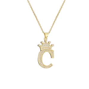 Detail of gold-plated crown letter C pendant necklace with sparkling zircon inlay