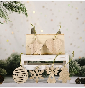 Detail of wooden Christmas ornaments with stars and trees on a warm festive background