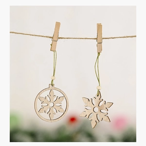 Detailed view of hollow wooden snowflake ornaments with green cords and beads for Christmas