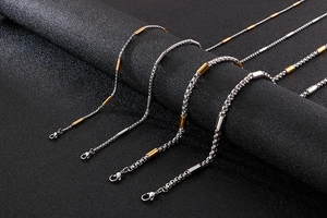Detail of creative square pearl and stainless steel chains in gold and silver finishes