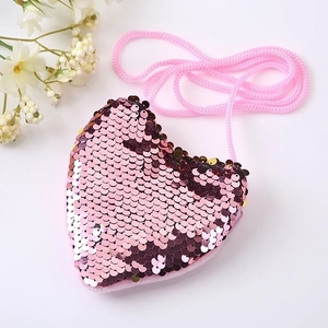 Detail view of pink heart-shaped sequin purse with matching woven shoulder strap