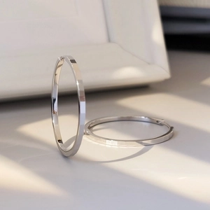 Detail of S925 silver hoop earrings featuring geometric faceted texture and polished finish
