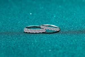 Macro shot of two 925 sterling silver eternity rings with round cut moissanite stones