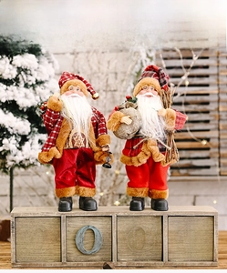 Detailed close-up of standing Santa Claus dolls with red plaid outfits and gift bags