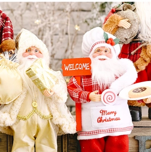 Detail of chef and golden Santa Claus dolls with Merry Christmas and Welcome signs
