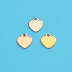 Detailed view of heart-shaped metal pendants in silver, gold, and rose gold finishes