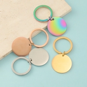 Flat lay of polished round stainless steel keychains in rainbow, rose gold, silver, and gold