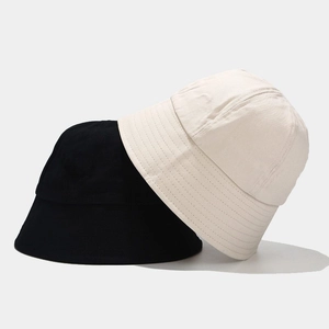 Women's minimalist cotton bucket hats in black and beige with durable stitched brims