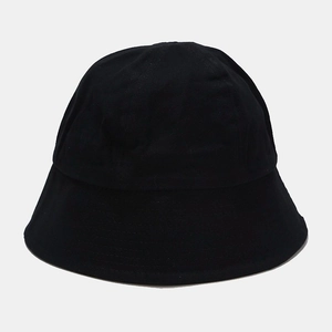 Close-up of a plain black bucket hat showing the reinforced stitched brim and cotton canvas