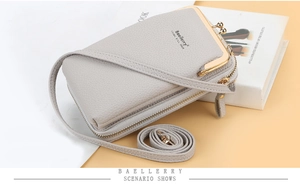 Detail view of light grey litchi texture leather crossbody phone bag with metal clasp