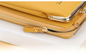 Macro shot of yellow leather wallet showing high-quality metal zipper and buckle detail