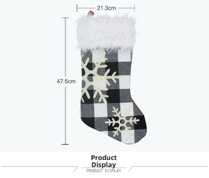 Detail of buffalo plaid Christmas stocking with white faux fur trim and snowflake accents