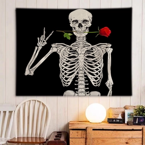 Detail of wall tapestry featuring black skull with red rose in an indoor home setting