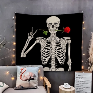 Detail of wall tapestry featuring skull with red rose and decorative star lights