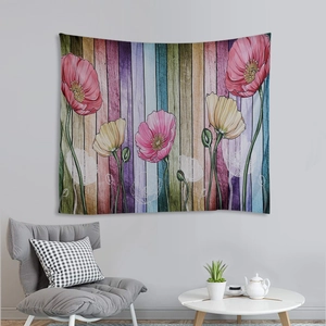 Artistic wall tapestry with mountain and poppy flower design on rustic wood backdrop