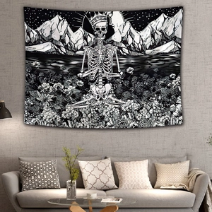 Detail of gothic black and white skull tapestry featuring a crown and floral mountain scenery
