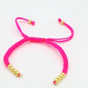 Detail of adjustable pink braided rope bracelet with polished gold beads and sliding knot
