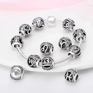 Silver zodiac charm bracelet with snake chain and crystal-studded constellation beads