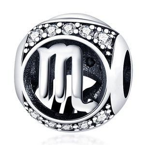 Detailed macro view of silver Scorpio zodiac charm with sparkling cubic zirconia stones