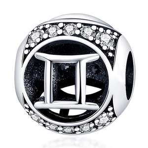 Macro view of silver Gemini zodiac charm with sparkling white crystals for DIY bracelets