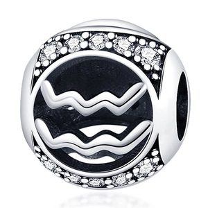 Macro detail of silver Aquarius charm with white zircon micro-pave and wave symbol