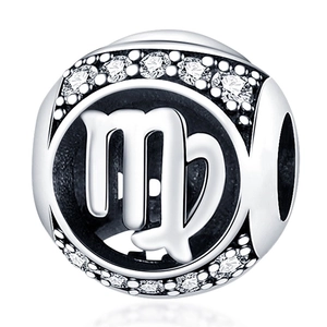 Macro view of silver Virgo zodiac charm with sparkling cubic zirconia stones and cutout