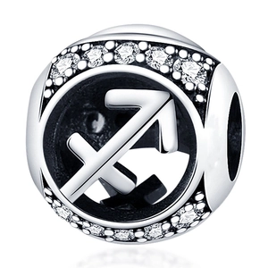 Macro view of silver Sagittarius zodiac charm with shimmering cubic zirconia stones