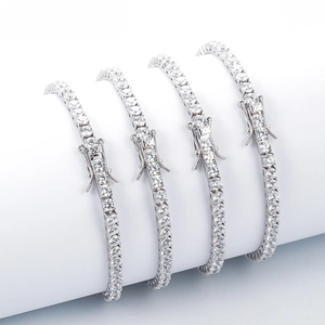 Close-up of four silver tennis bracelets with clear round stones and secure safety clasps