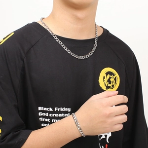 Men's silver stainless steel Cuban link necklace and bracelet set shown on model