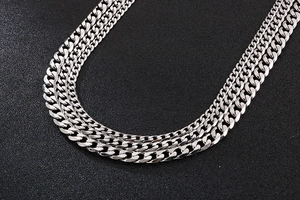 Close-up of polished silver stainless steel curb chain with multi-layer metal links