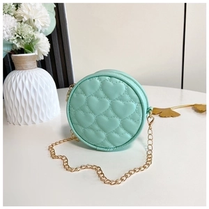 Detail of mint green quilted round mini bag with heart pattern and gold chain strap