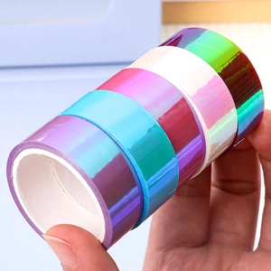 Stack of colorful holographic laser tapes with vibrant gradient reflective metallic finish