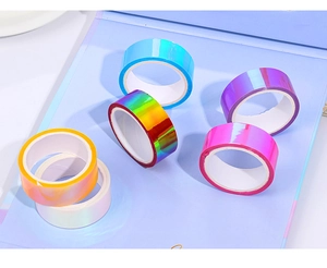 Close-up of 6 rolls of colorful holographic laser decorative tapes on a notebook