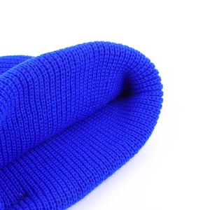 Macro shot showing the ribbed texture and royal blue knit fabric of the warm beanie