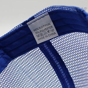 Detail of blue mesh baseball cap showing 65% cotton label and internal stitching