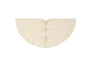 Detailed view of beige knitted mini tree skirt with three delicate ribbon bow ties