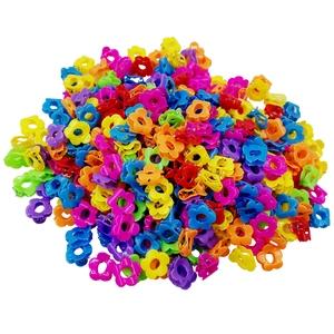 Close-up of colorful mini flower hair claws in a variety of vibrant plastic shades