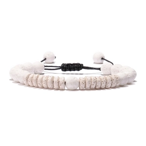Detail of white volcanic stone beads and flat discs with black braided adjustable cord