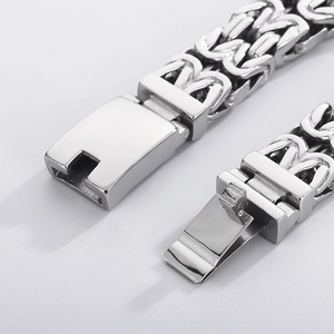 Macro detail of silver stainless steel Byzantine chain with secure lobster clasp closure