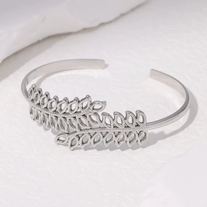 Silver stainless steel open cuff bracelet featuring elegant hollow leaf design in a minimalist style