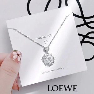 Elegant silver tulip heart necklace with sparkling diamonds on a display card